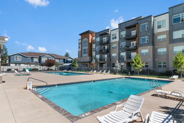 Outdoor swimming pool with integrated steps, surrounded by a concrete deck