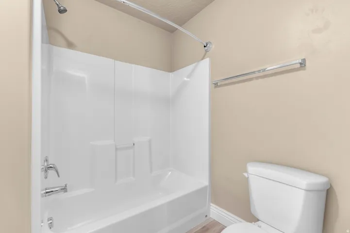 White tub/shower combination with chrome fixtures