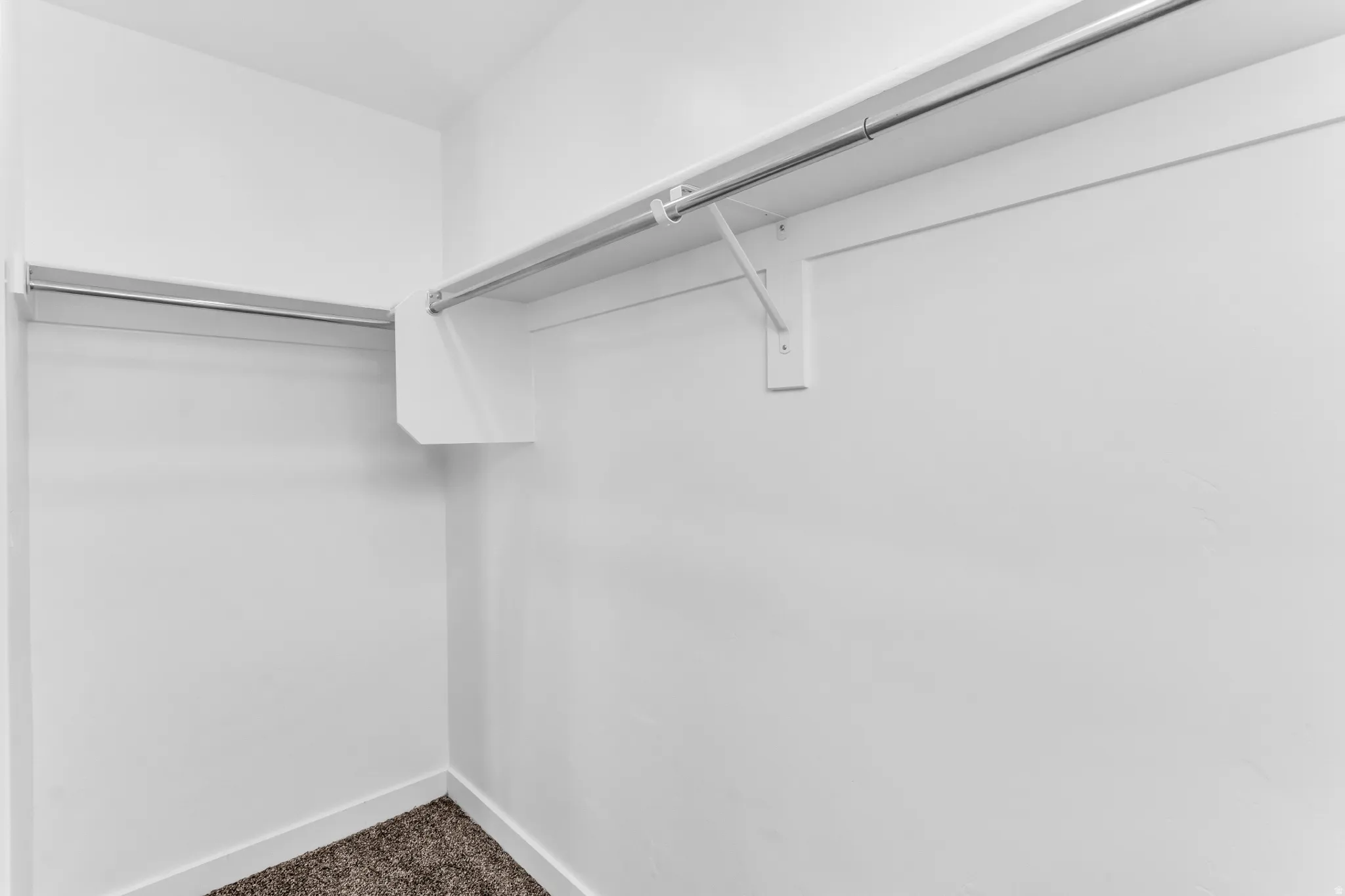 Built-in shelving with hanging rods and neutral wall finishes