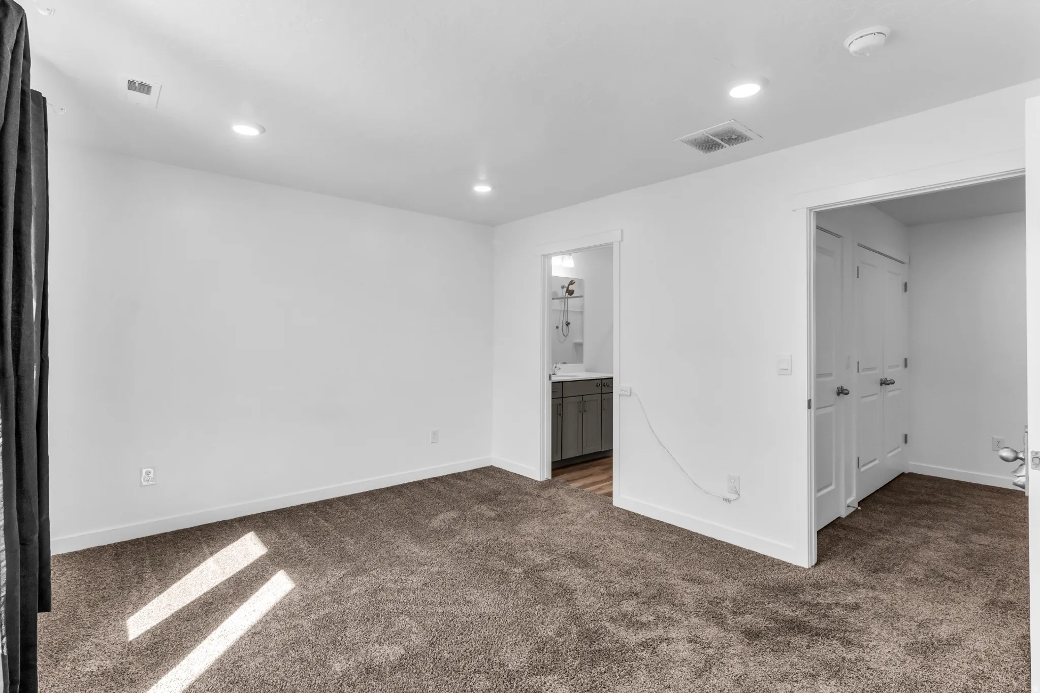 Recessed ceiling lighting, gray carpet flooring, white walls, and white trim