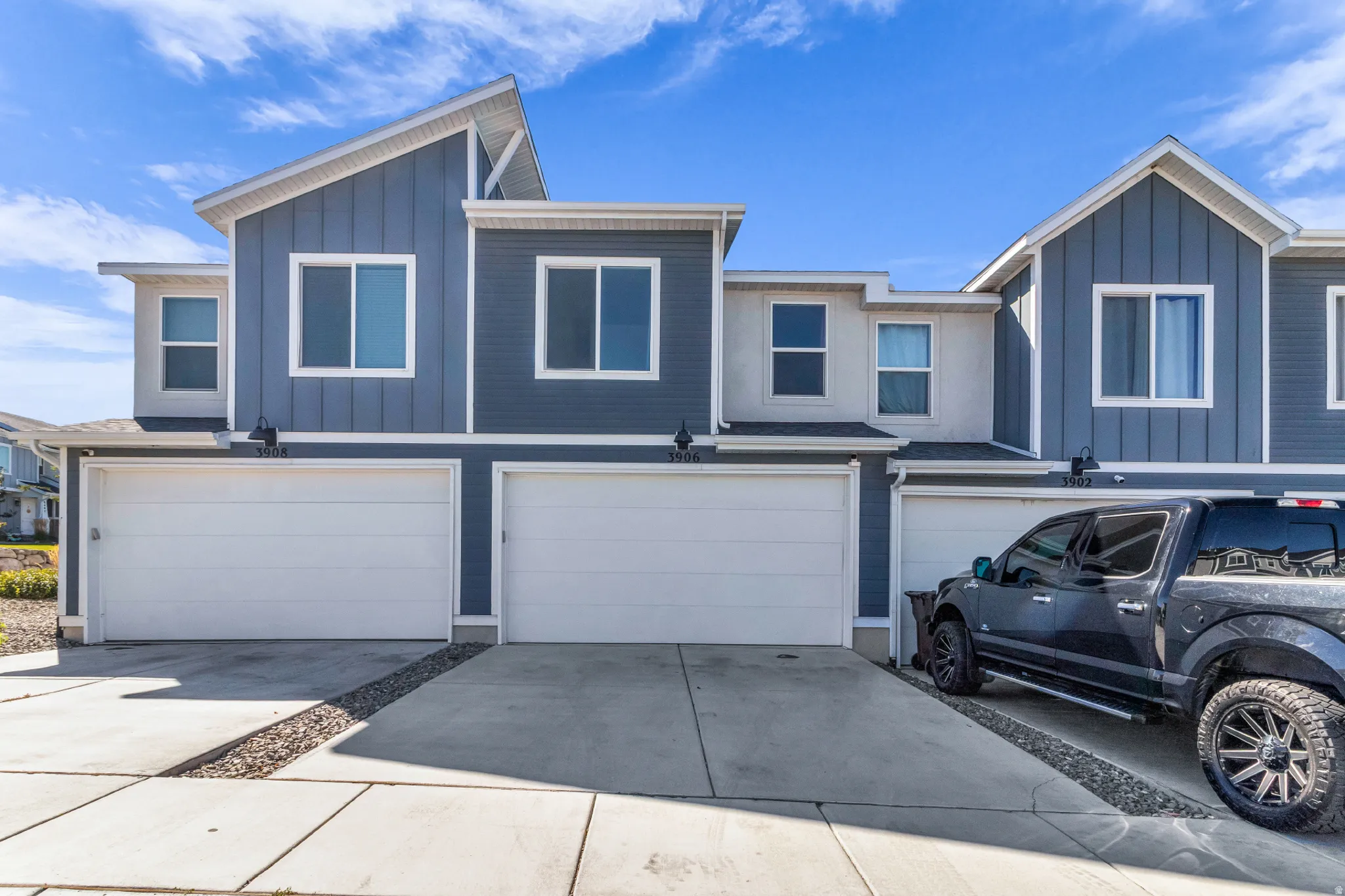 Modern facade featuring vertical siding and stucco accents