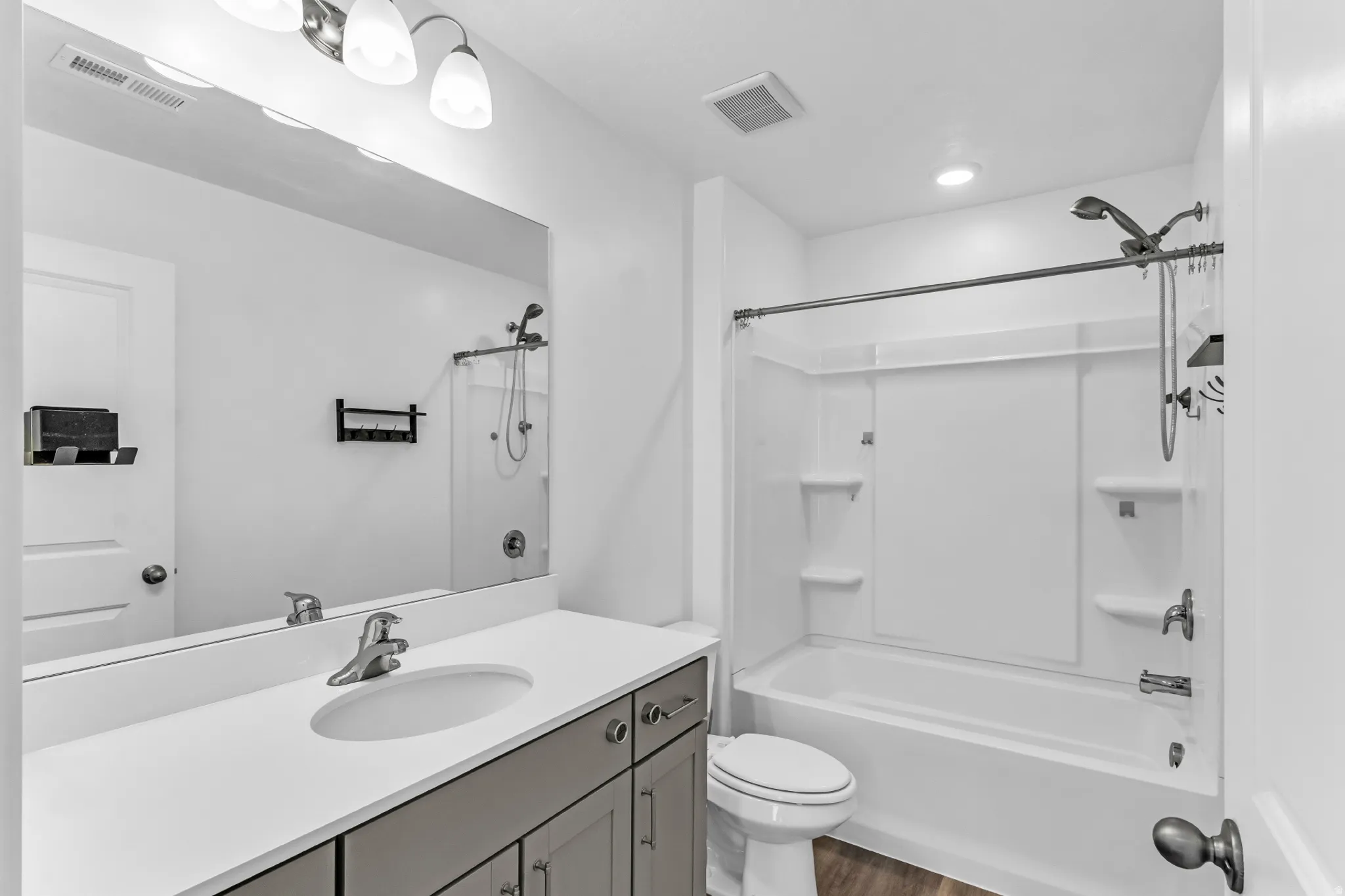 Bathroom featuring a vanity with a white countertop, undermount sink, and brushed nickel faucet