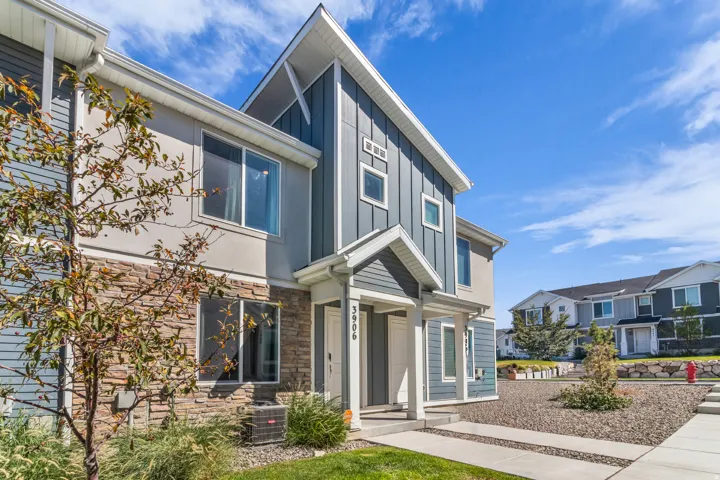 Contemporary exterior featuring mixed material siding, stone accents, and a covered entry