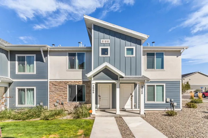 Contemporary exterior with a prominent angular roofline, board and batten siding, and stone accents