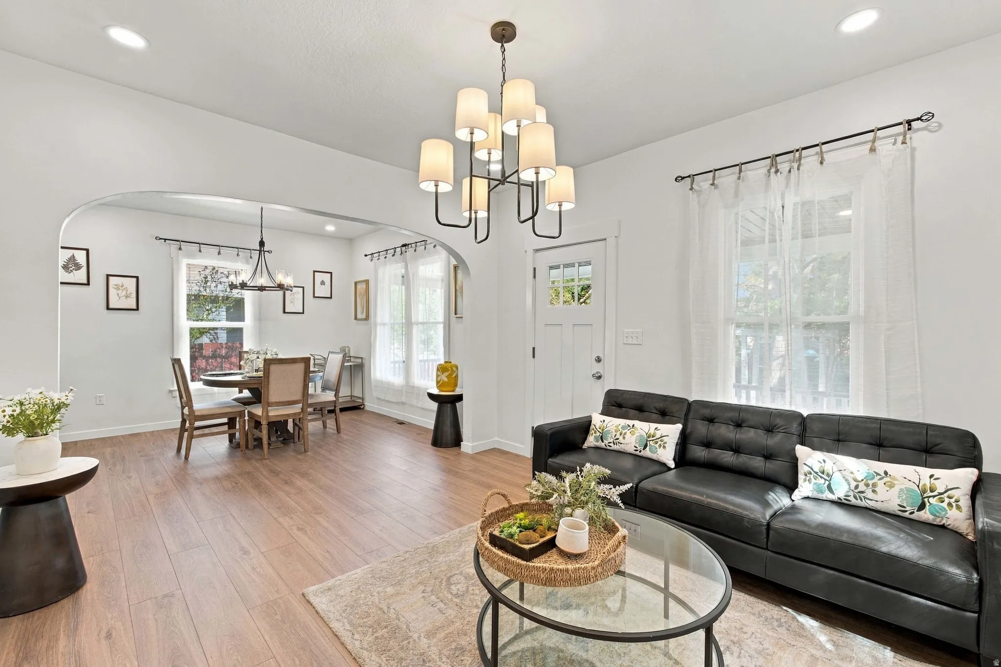 Recessed lighting, wood-finish flooring, arched doorway, and built-in lighting fixtures