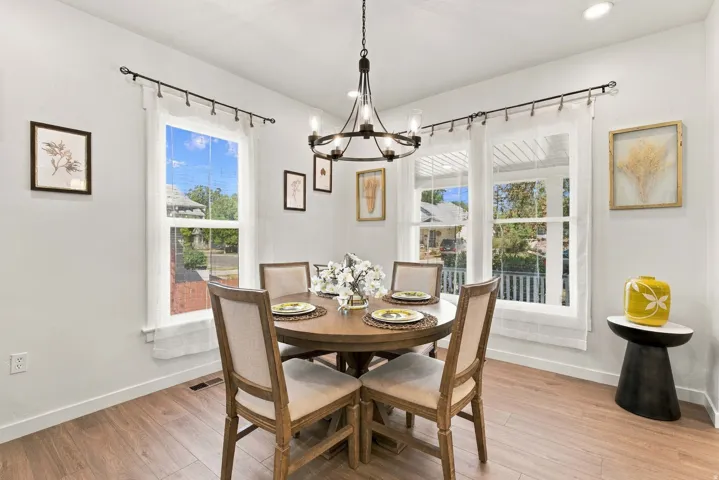 Bright dining space featuring wood-finish flooring, recessed lighting, and ample natural light from multiple windows