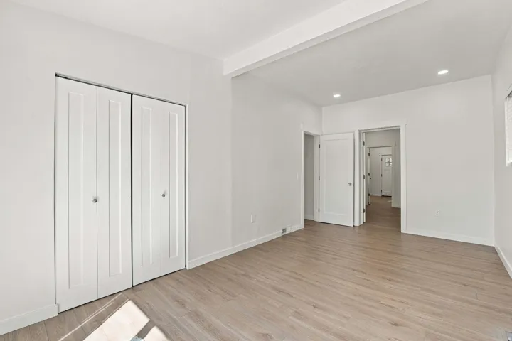 Light wood-finish flooring with white walls