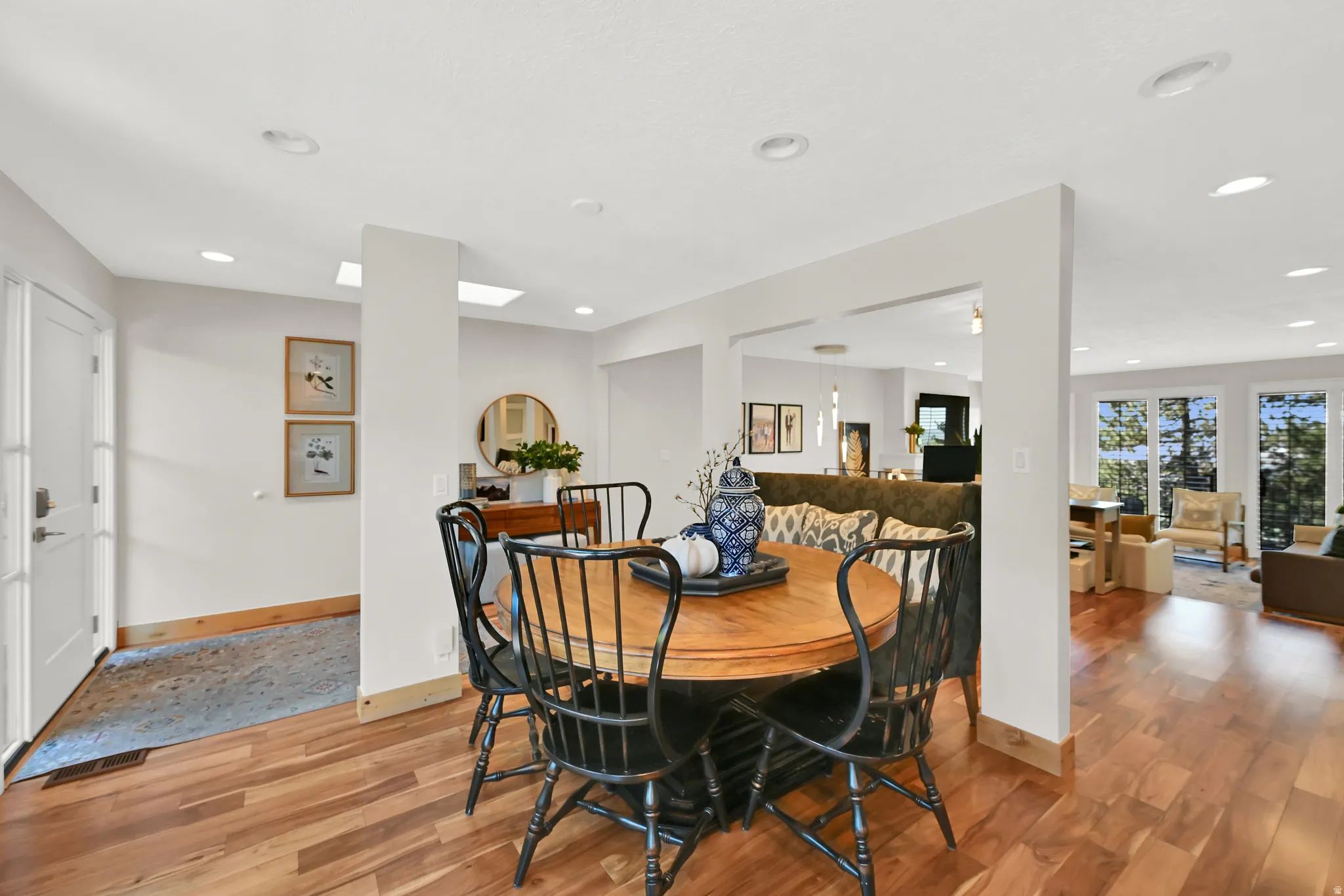 Hardwood flooring throughout, recessed lighting, white interior doors, and skylights