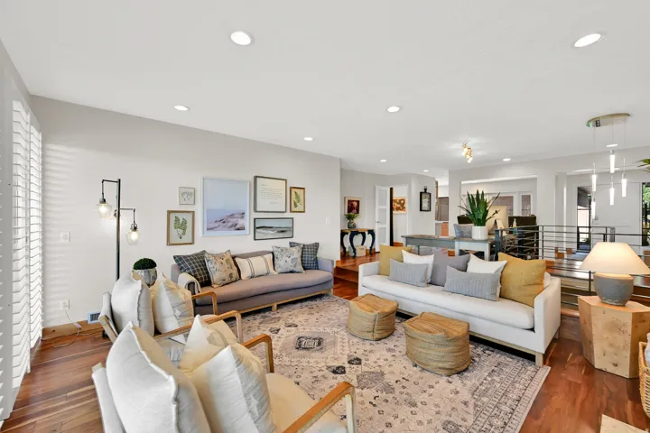 Recessed lighting, wood-finish flooring, plantation shutters, and an open concept layout