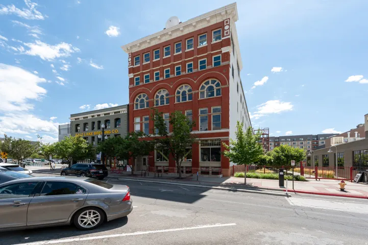 Brick facade building featuring arched windows, multiple stories, and street-level access