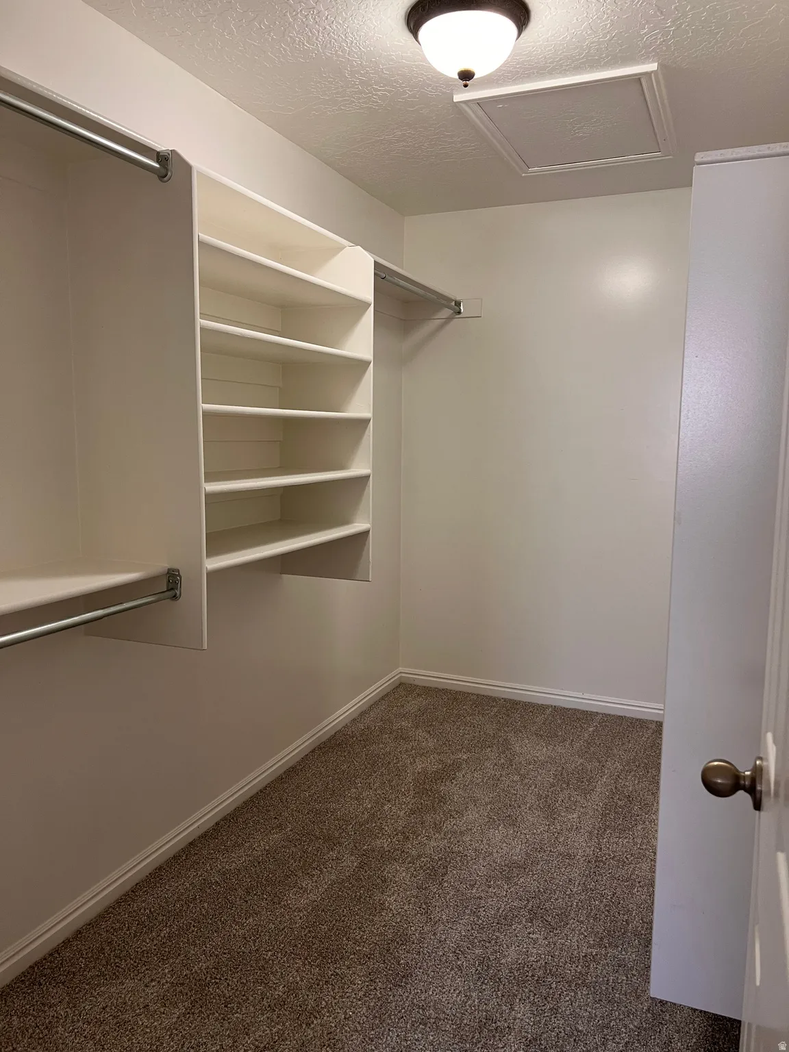 Primary bedroom closet, new carpet, new paint