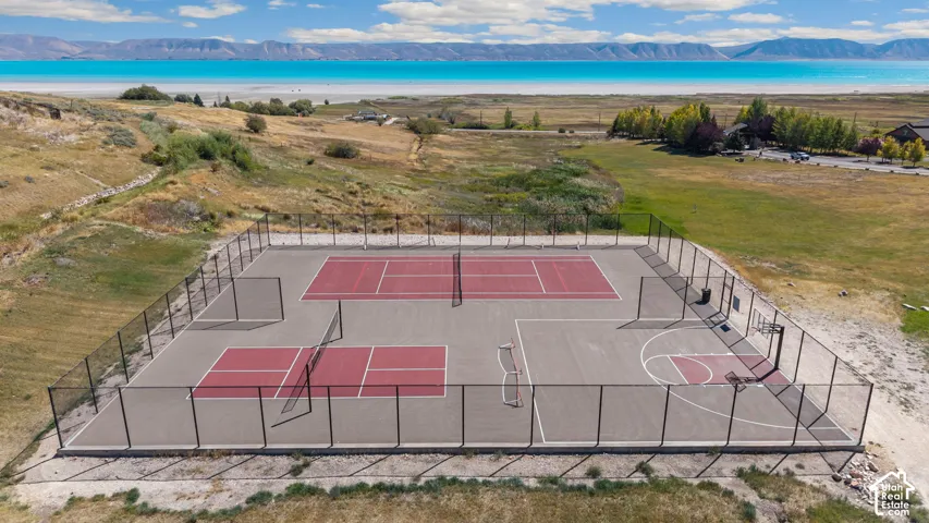 Multi-sport court featuring two pickleball courts, a tennis court, and a basketball court, all enclosed by fencing