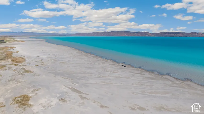 Expansive shoreline with turquoise water and mountainous backdrop
