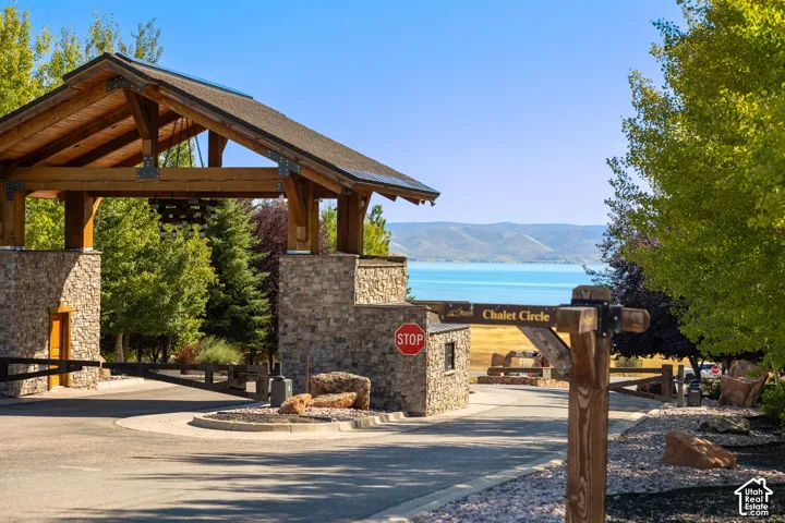 Gated entry with stone columns and wood-beam archway