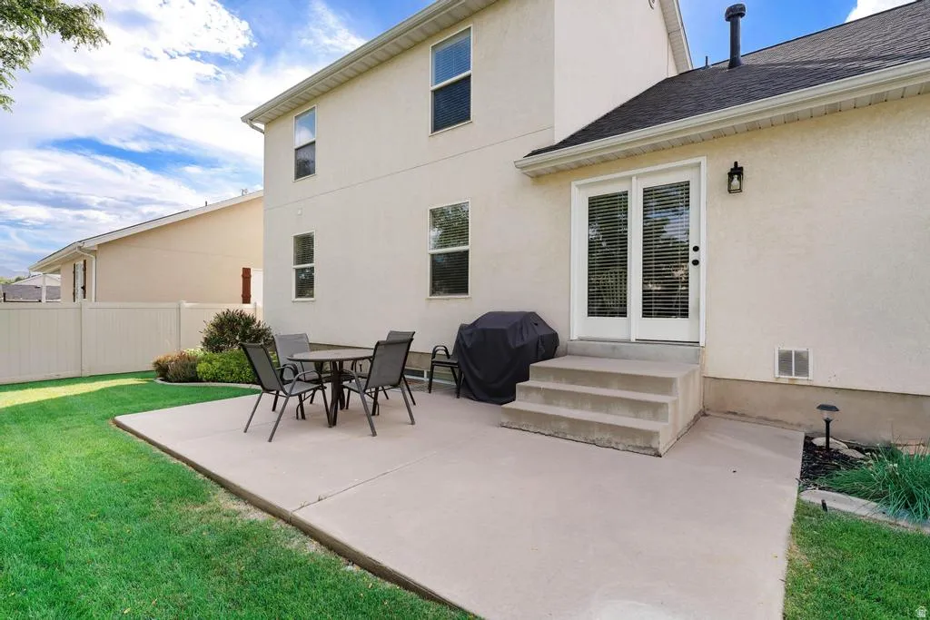 Expansive concrete patio with direct access to the interior via double glass doors