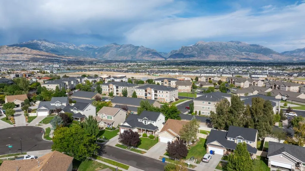 Residential neighborhood with single-family homes and multi-story buildings, featuring varied architectural styles and mature landscaping