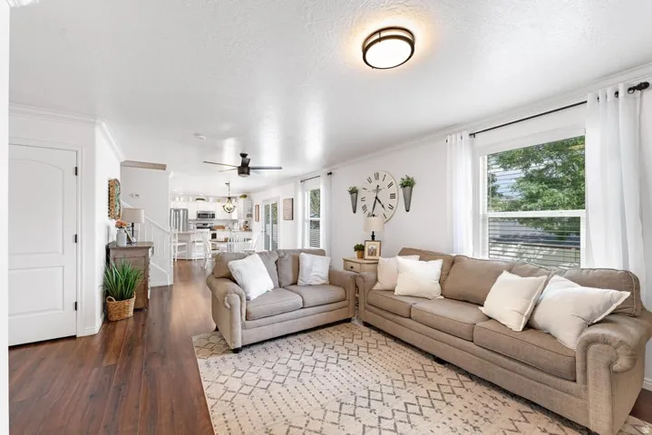 Wood-finish flooring, white walls, and a contemporary ceiling light