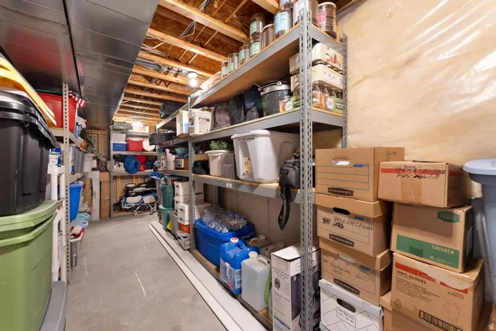 Unfinished basement with exposed ceiling joists and concrete flooring