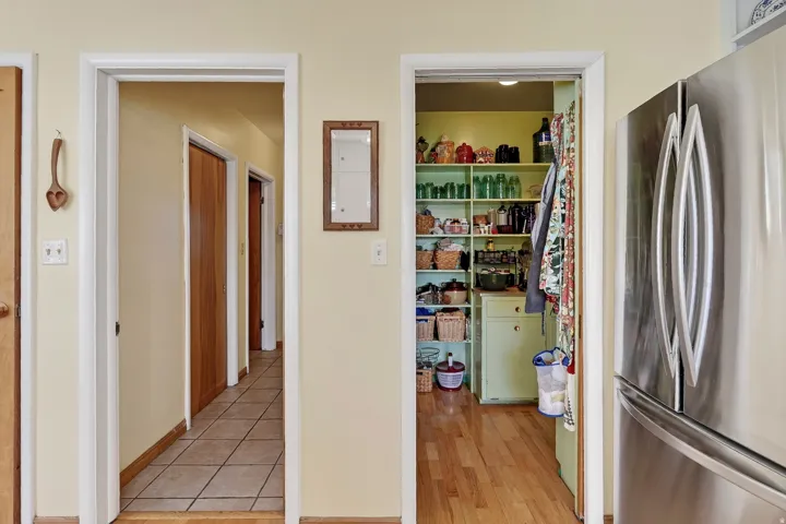 Hallway with tile flooring and wood doors