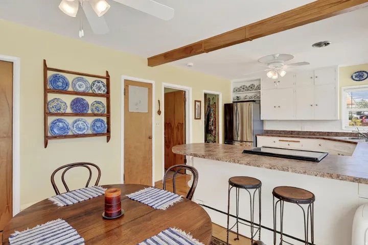 Kitchen featuring white cabinetry, light countertops, and a stainless steel refrigerator