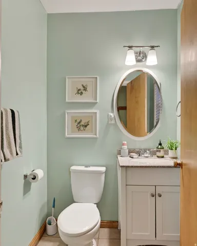 White vanity with paneled doors and a light-colored countertop