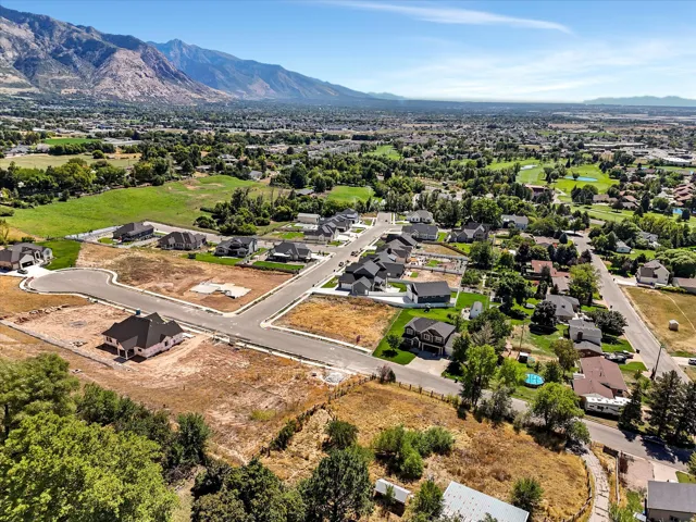 Expansive community with mountain backdrop, new construction homes, established residences, and paved roadways