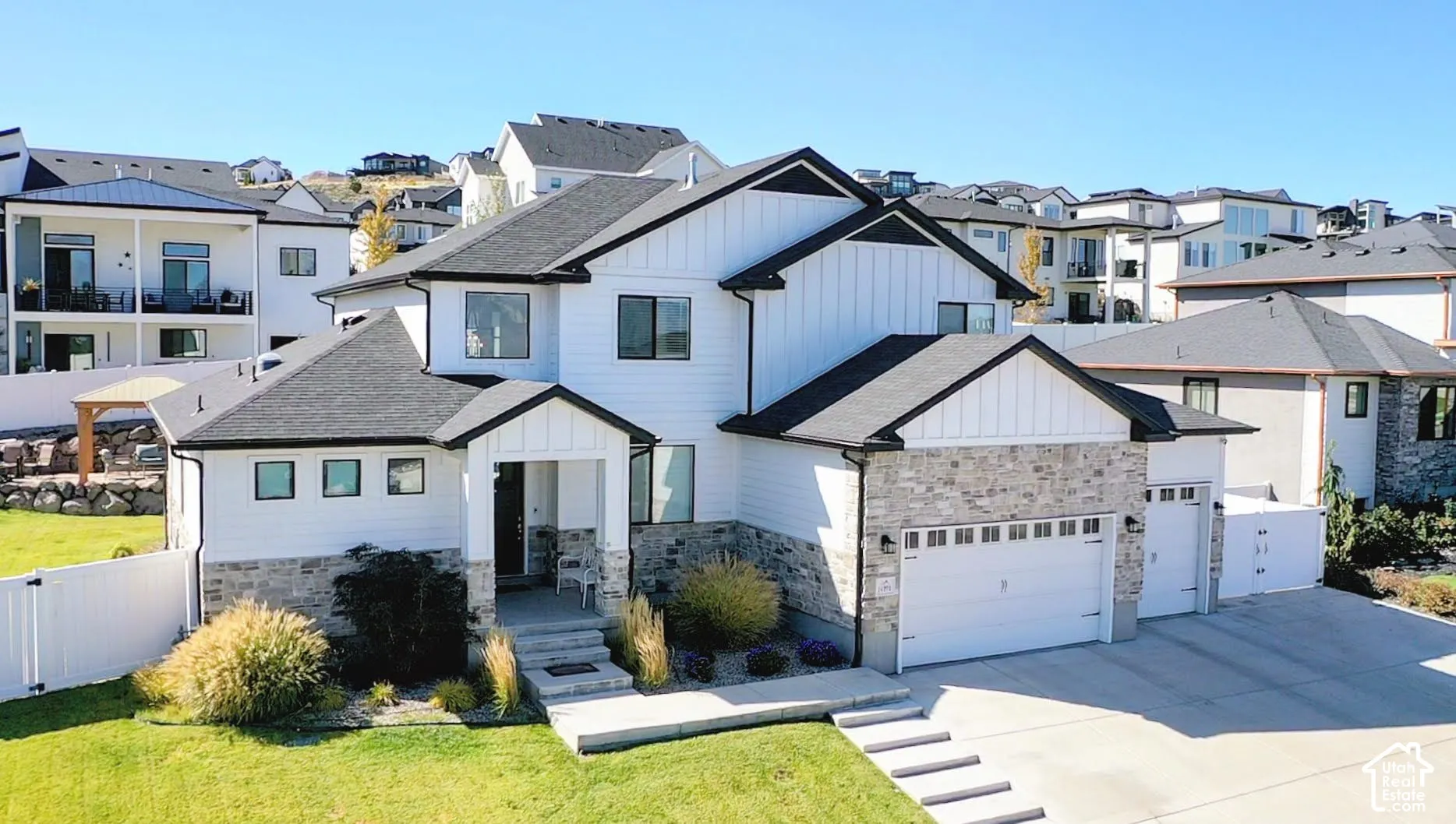 Contemporary exterior with white siding and dark trim