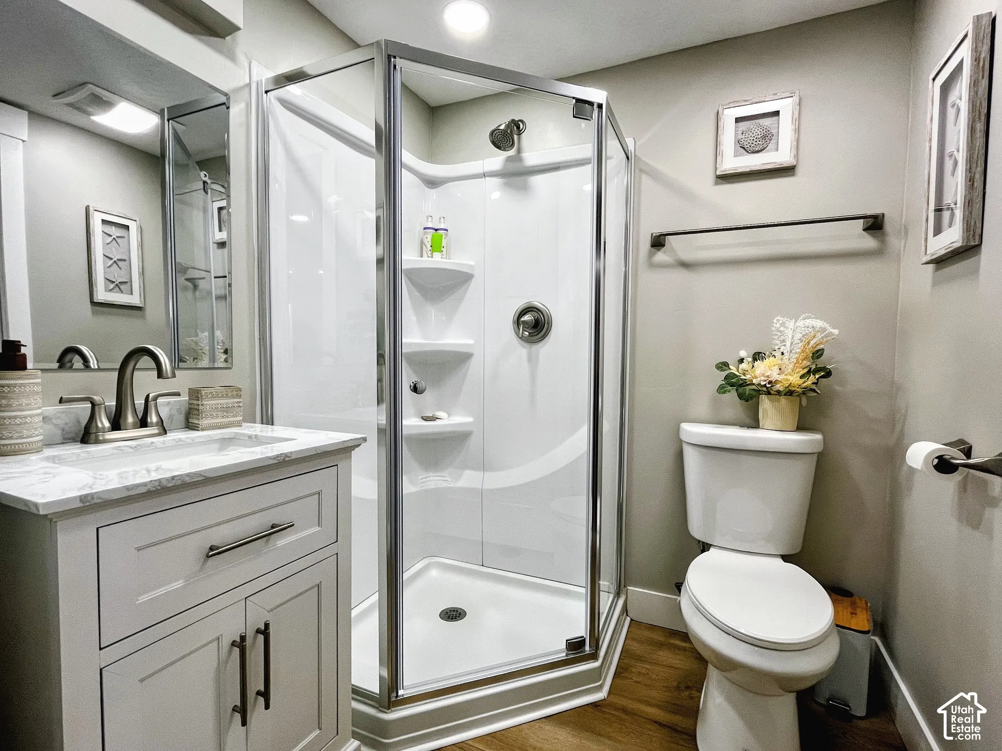 Vanity with a marble-finish countertop and brushed nickel faucet