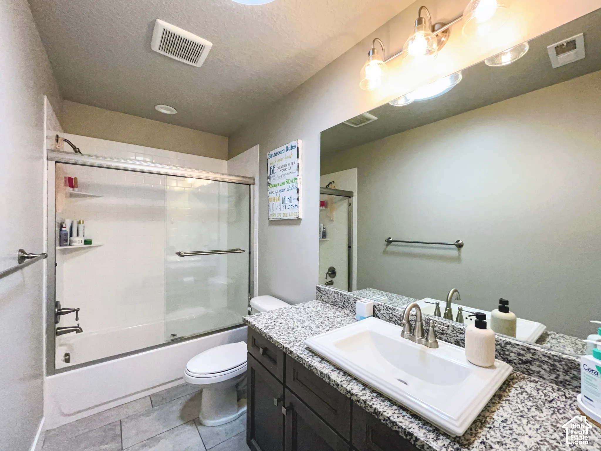 Granite-finish countertop with an integrated rectangular sink and brushed nickel faucet