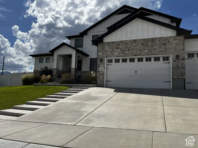 Modern exterior with white siding and stone accents