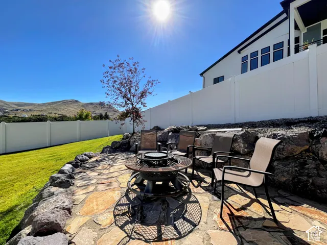 Stone patio featuring a fire pit