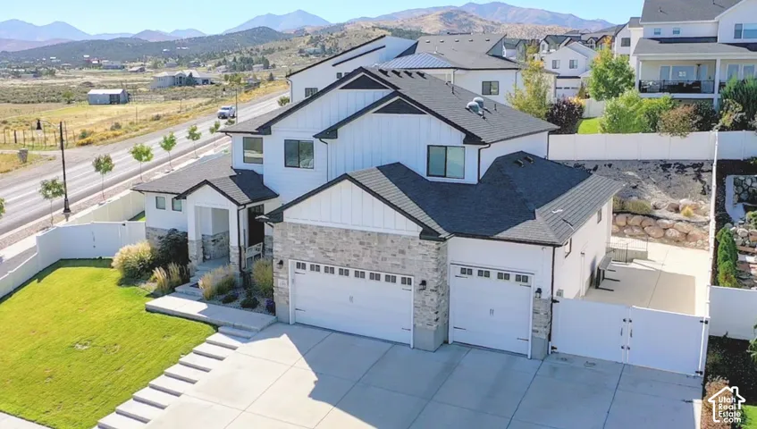 Modern two-story residence with white siding and dark roofing