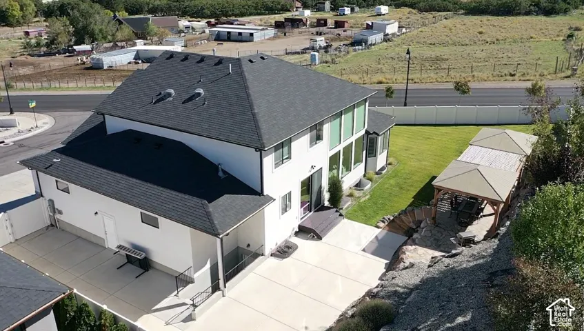 White stucco exterior with a dark shingle roof