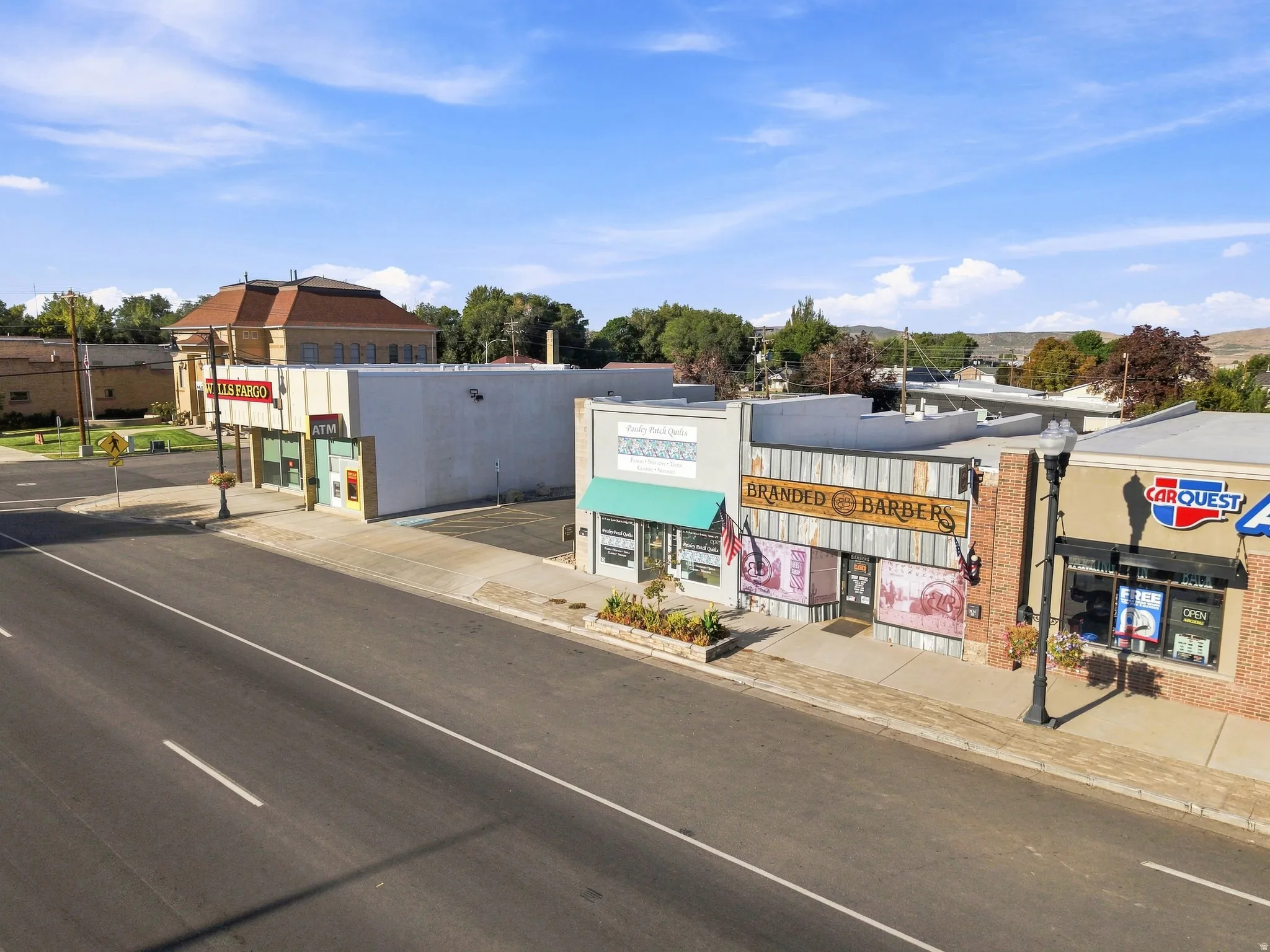 Commercial storefronts with direct street frontage, visible signage, and established neighboring businesses
