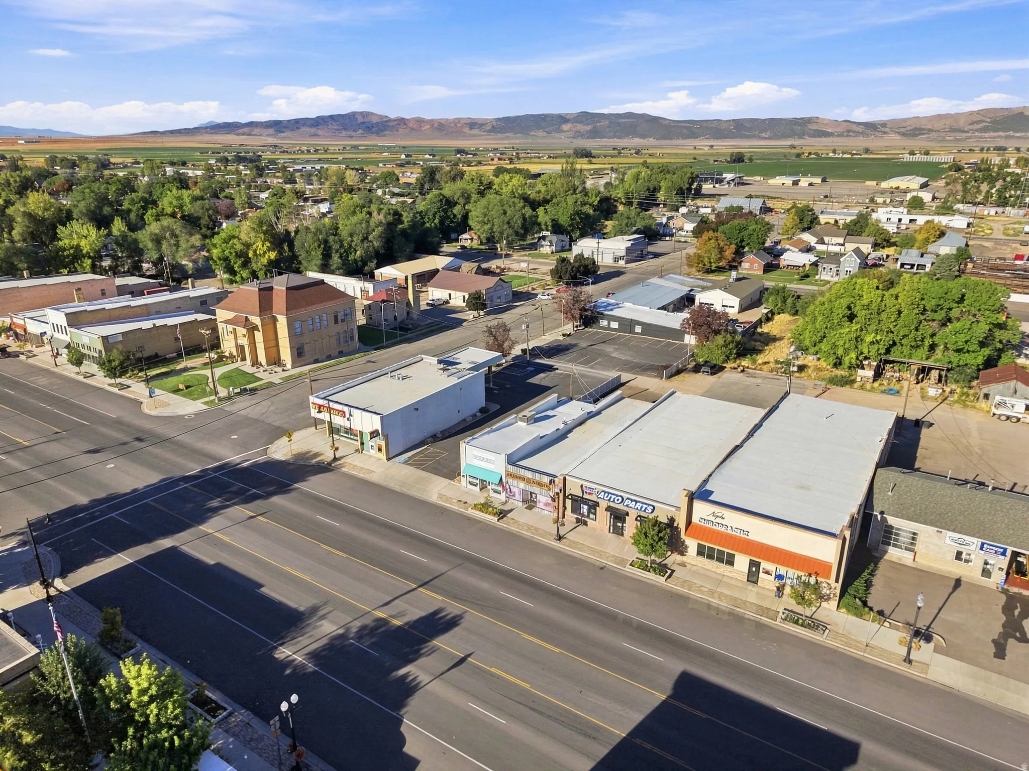 Commercial buildings with flat roofs, paved roadways, and mountain backdrop