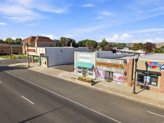 Commercial storefronts with direct street frontage, visible signage, and established neighboring businesses