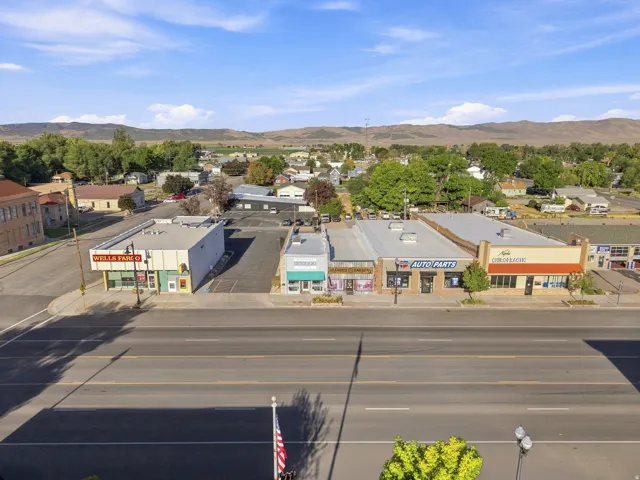 Commercial buildings lining a paved street with distinct storefronts and signage