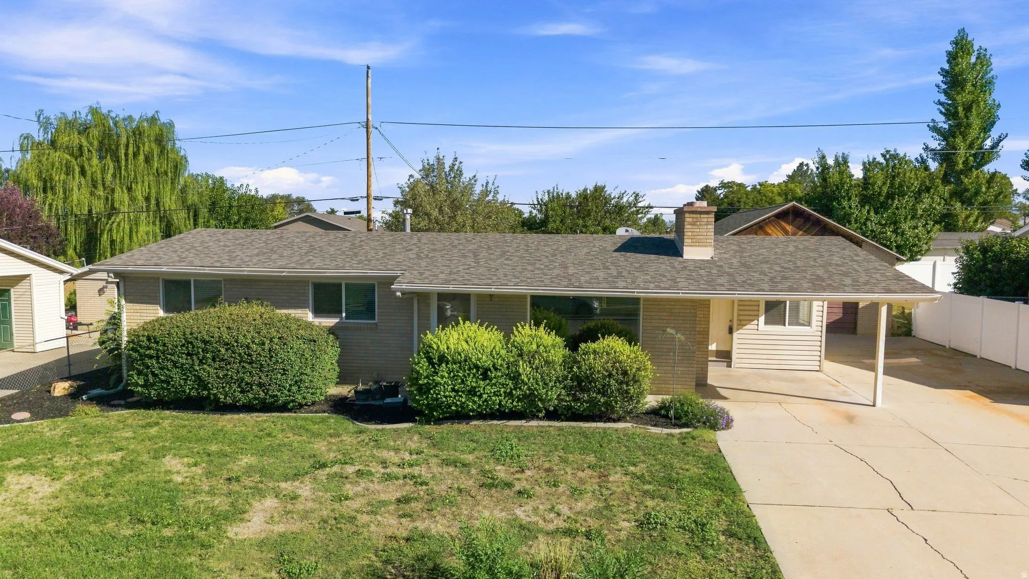 Ranch-style residence covered patio, brick exterior and fully landscaped, fenced yard