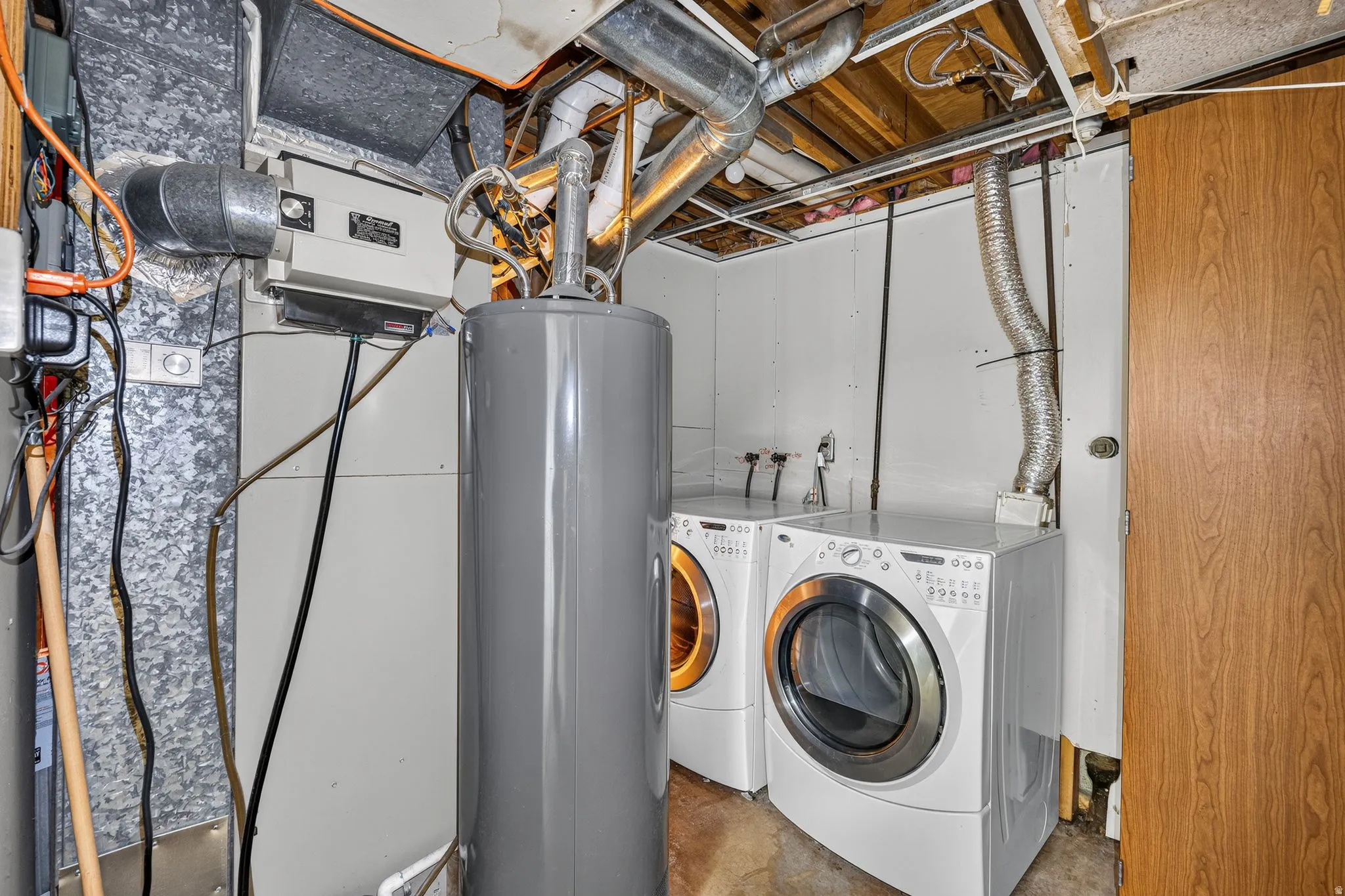 Large utility room featuring laundry area and storage.