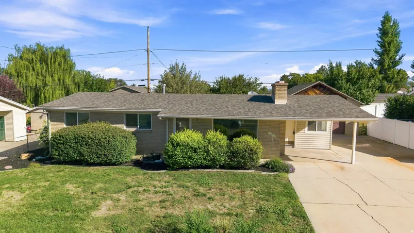 Ranch-style residence covered patio, brick exterior and fully landscaped, fenced yard