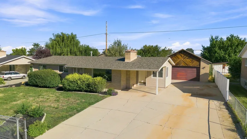 Brick exterior with a peaked roof and a large two-car garage