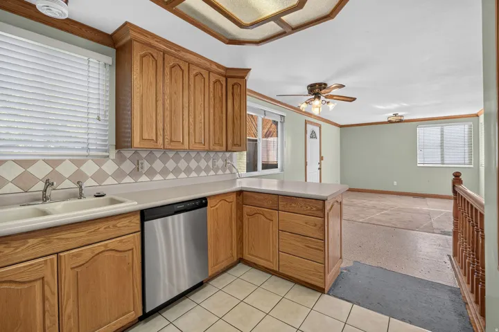 Open Kitchen featuring tile flooring,  a stainless steel dishwasher, clear view to spacious dining