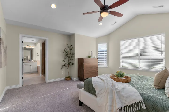 Vaulted ceilings, recessed lighting, and a ceiling fan with integrated light