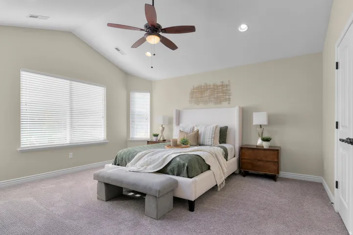 Vaulted ceiling with a ceiling fan, recessed lighting, carpet flooring, and multiple windows with blinds