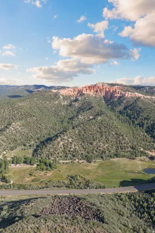Mountainous landscape featuring extensive green foliage and natural rock formations