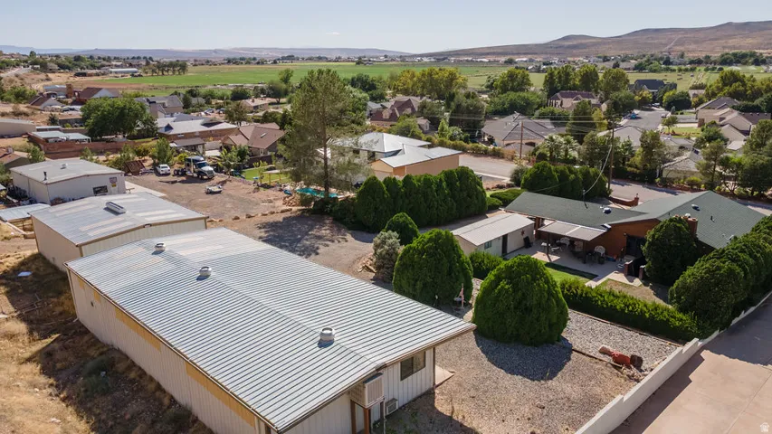Expansive commercial or agricultural property featuring a modern metal-roof structure with clean lines and efficient layout