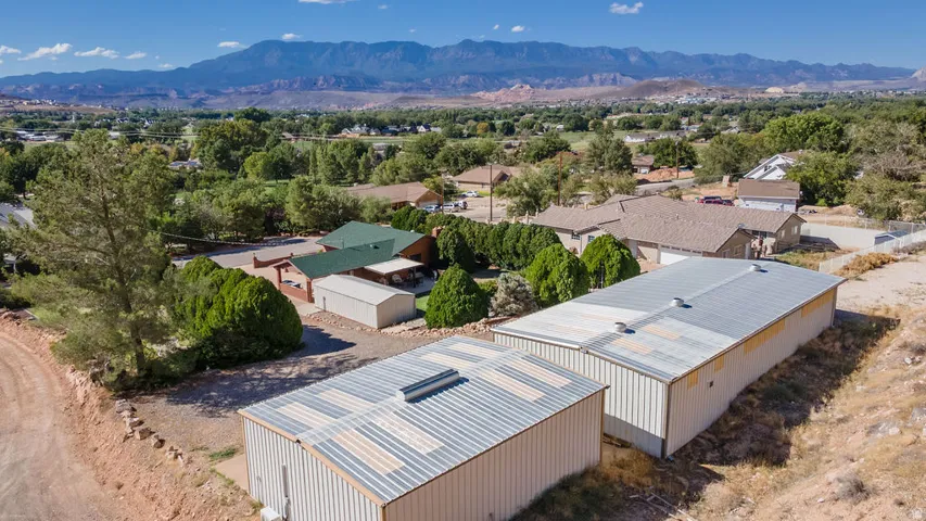 Two large metal outbuildings with corrugated roofs
