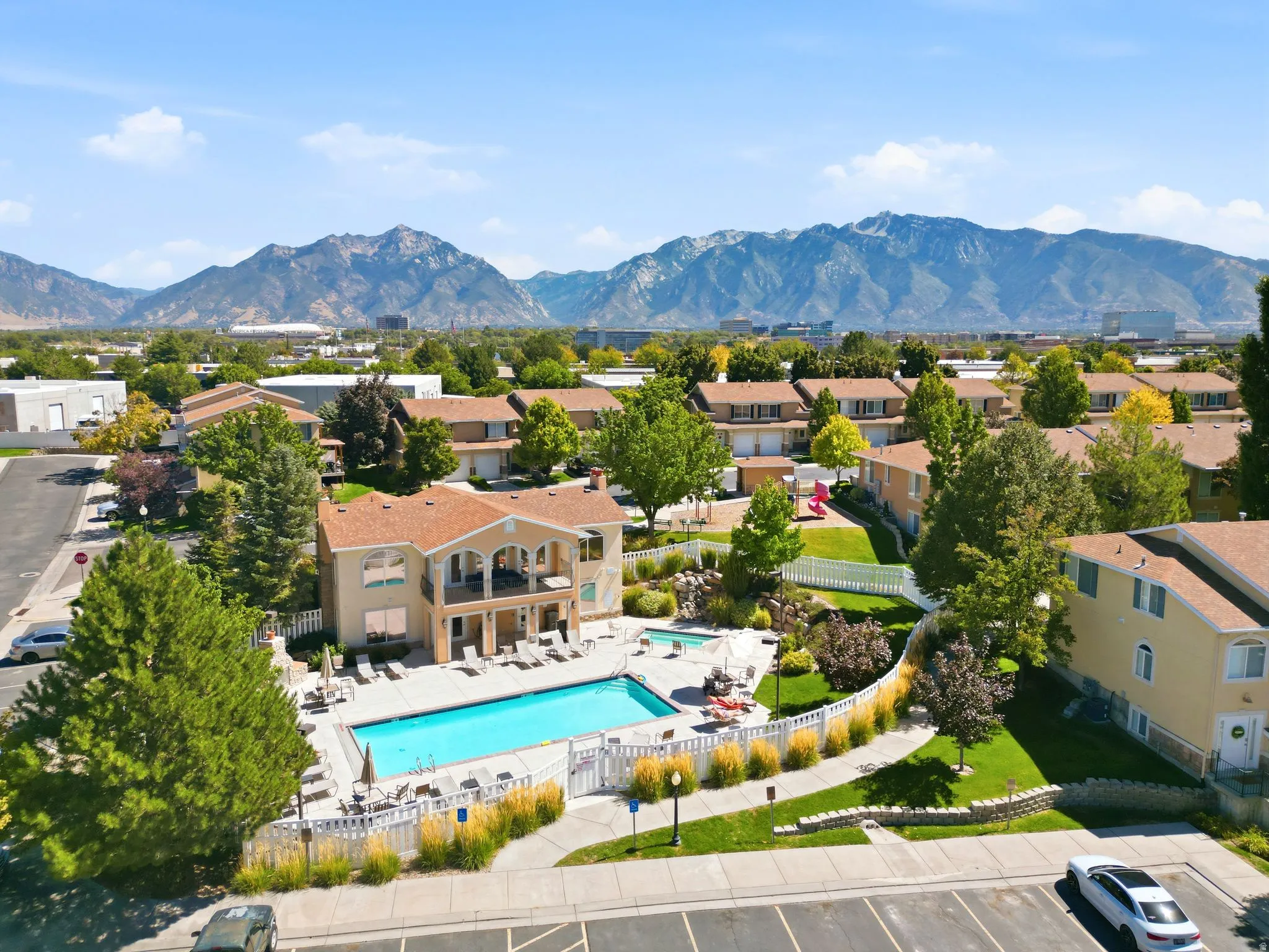 Community amenities featuring a swimming pool, adjacent lounge areas, and landscaped grounds