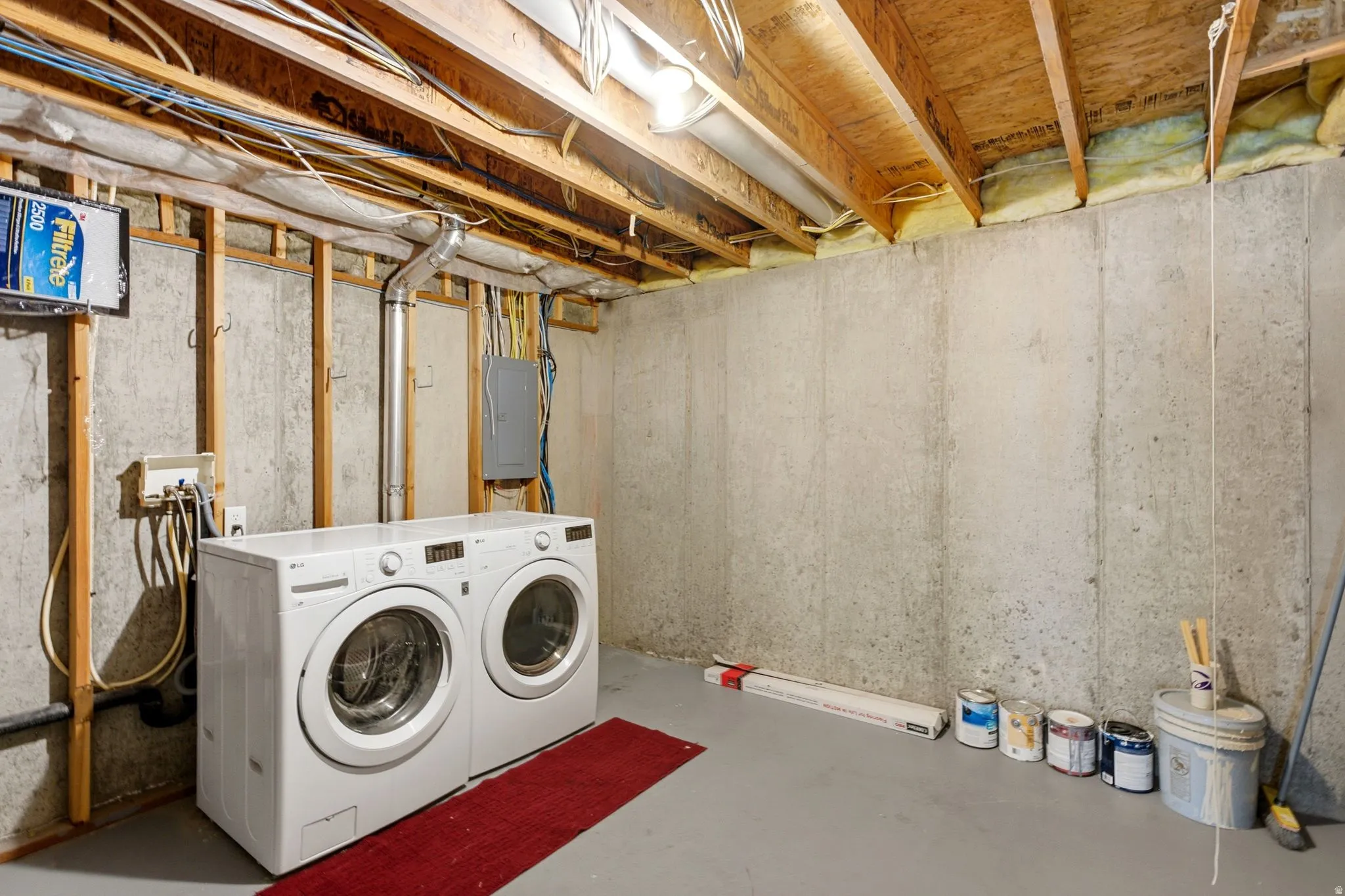 Concrete foundation walls with exposed wood framing and ceiling joists