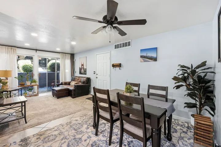 Spacious living area featuring a ceiling fan, recessed lighting, and sliding glass doors
